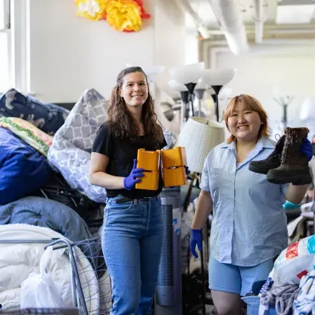 Jena Kim and Molly Neu sorting through items at SmithCycle in Scales House basement